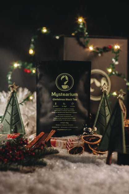 Mysterium Christmas Black Tea package with festive decorations in the background
